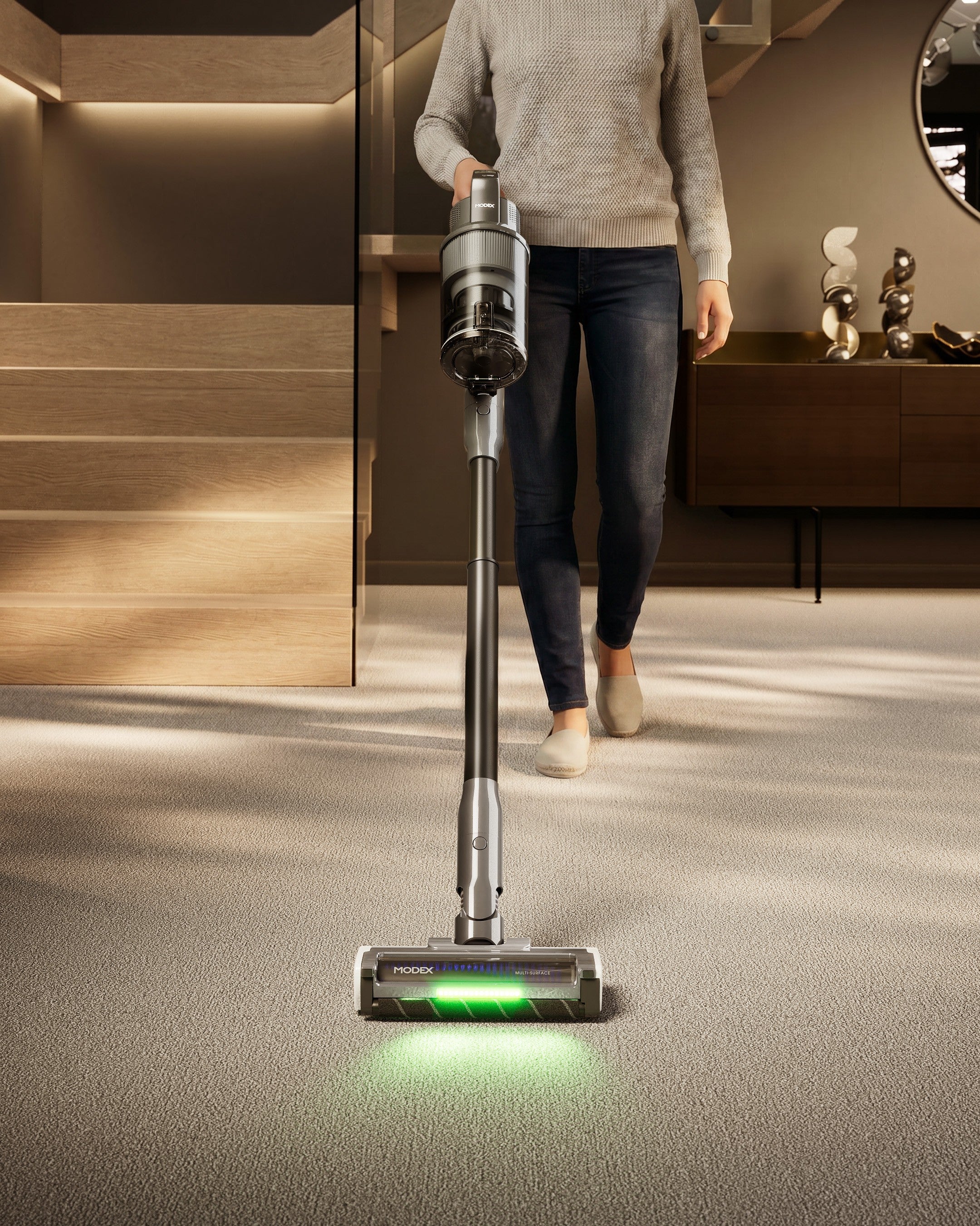 MODEX HVC1440 cordless vacuum with green dust light in a hallway | مكنسة مودكس اللاسلكية مع ضوء أخضر لكشف الغبار في الممر